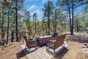 a group of chairs sitting around a table in the woods at Wild West Wonder in Pinetop-Lakeside