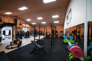 a gym with lots of equipment in a room at Sea view Ella - Hejlsminde Badehotel in Hejlsminde