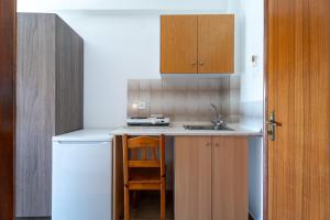 a small kitchen with a sink and a counter at Studios Vaso in Neos Marmaras +16 photos