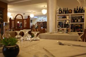 ein Restaurant mit einem Tisch voller Gläser und Flaschen Wein in der Unterkunft Italia Risorta in Arsiero