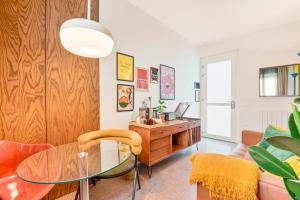 a living room with a glass table and a desk at CasaMichelin in Marina di Massa