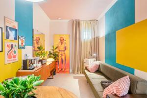 a living room with a couch and colorful walls at CasaMichelin in Marina di Massa