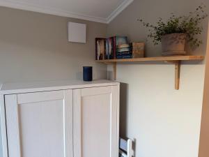 a room with a white cabinet with books at Stuga Marstrand in Marstrand