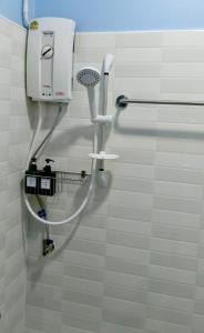 a shower in a bathroom with a hair dryer at Khaosok Bluesky Hotel in Khao Sok National Park +55 photos