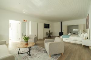 a bedroom with a bed and a table and chairs at theLAB BLUE in Franschhoek