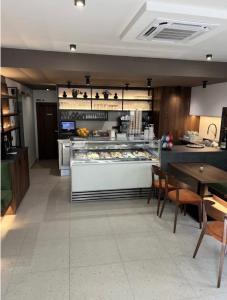 a kitchen with a counter and a table with chairs at Rooms Aura Kanal in Kanal