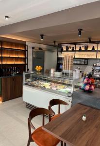 a restaurant with a table and a display case at Rooms Aura Kanal in Kanal