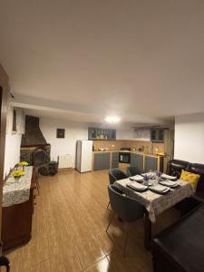 a kitchen and living room with a table and chairs at Cabana Patru Anotimpuri in Rîmeţi +46 photos