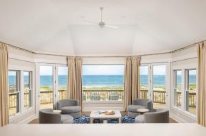 a living room with a view of the ocean at The Sanderling in Duck