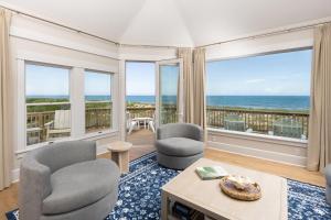 a living room with a view of the ocean at The Sanderling in Duck
