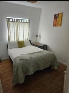 a white bedroom with a bed with a window at Galway Break in Galway