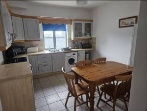 a kitchen with a wooden table and chairs in a kitchen at Galway Break in Galway