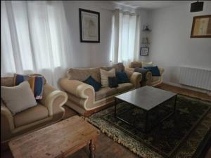 a living room with two couches and a coffee table at Galway Break in Galway