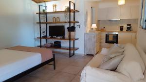 a living room with a white couch and a kitchen at Sofia Limeni in Limeni