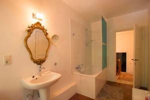 a bathroom with a sink and a mirror and a tub at Gîte du Château de Spontin - 7a chaussée de Dinant - 5530 Spontin in Spontin