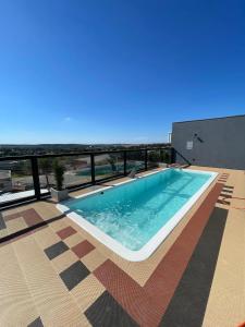 a swimming pool on top of a building at HOTEL SB Butia in Butiá