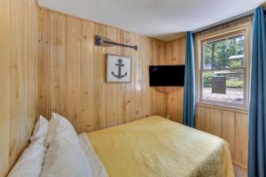 a bedroom with a bed and a window at Lakeside Reeds Spring Home w/ Deck & Pool Access! in Reeds Spring +18 photos