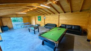 a living room with a pool table in it at Siesta Camp Łeba in Nowęcin