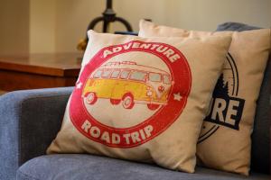 a pillow on a couch with a red and yellow bus at Zephyr Mountain Lodge Unit 1306 in Winter Park