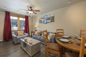 a living room with a table and a dining room at Zephyr Mountain Lodge Unit 1306 in Winter Park