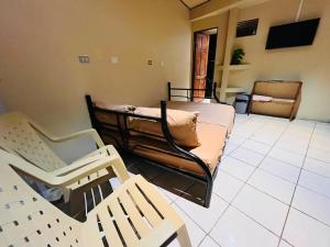 a living room with two beds and a couch at Hospedaje Doña koko in Puerto Limón