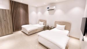 a hospital room with two beds and a tv at أرياف سويت in Al Baha