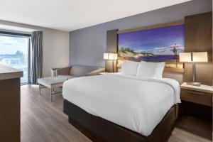 a hotel room with a bed and a large window at Best Western Belleville in Belleville +30 photos