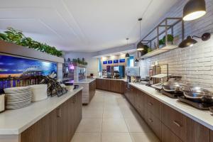 a large kitchen with wooden cabinets and plates on the counter at Best Western Belleville in Belleville
