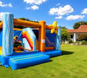 a inflatable bounce house on a lawn at Les Chênes verts in Saint-Savinien