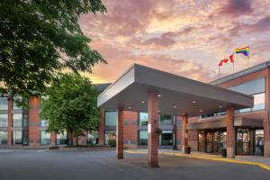 a building with two flags in front of it at Best Western Belleville in Belleville