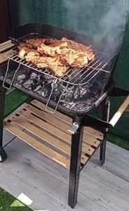 a grill with meat cooking on top of it at CasaLira in Castrillo de San Pelayo