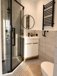 a bathroom with a shower and a sink and a toilet at GóralSki in Wisła +61 photos
