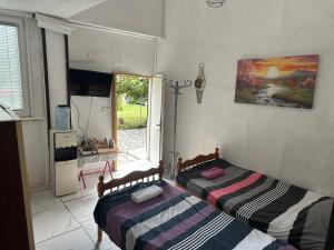 two beds in a room with a window at Rooms Struga free parking quiet area in Struga