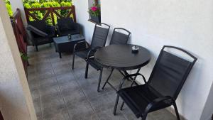 a table and chairs sitting on a balcony at Ubytovanie u Adama in Oščadnica