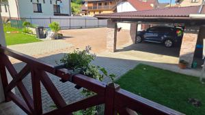 a car parked in a backyard with a car garage at Ubytovanie u Adama in Oščadnica