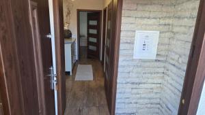 a hallway with a stone wall next to a door at Ubytovanie u Adama in Oščadnica +24 photos