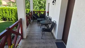a patio with chairs and a table on a balcony at Ubytovanie u Adama in Oščadnica