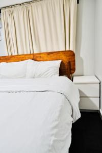 a bed with white sheets and pillows in a bedroom at Joynest Nest - Private Entry & Bath in Newark +2 photos