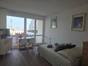 a living room with a bed and a table with chairs at Escale au Port du Crouesty in Arzon +15 photos