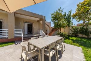 a table and chairs in the backyard of a house at Oasis Paradise Pool Villa in Durrës +35 photos