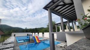a view of a swimming pool on the side of a building at Happy Time in Sredneye Vodyanoye +11 photos
