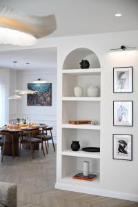 a white living room with a dining room table at Casa Magista in Sukošan
