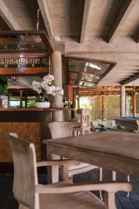 a dining room with a wooden table and chairs at Green Lodge Moorea in Teavaro