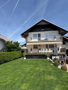 a house with a lawn in front of it at Ana Deluxe Apartment in Radovljica