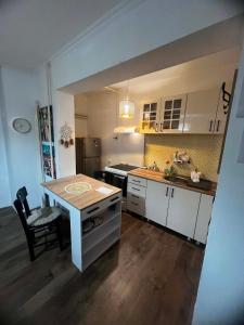 a kitchen with a table and a sink in it at Rio II in Zrenjanin