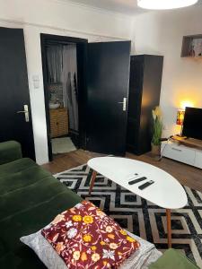 a living room with a surfboard on top of a couch at Rio II in Zrenjanin