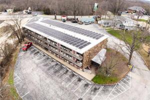 an office building with solar panels on the roof at Colonial Mountain Inn Branson MO in Branson West