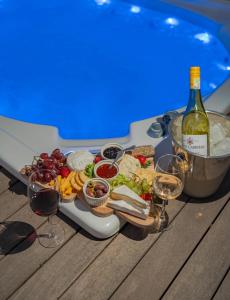 a tray of food and a bottle of wine and wine glasses at theLAB BLUE in Franschhoek