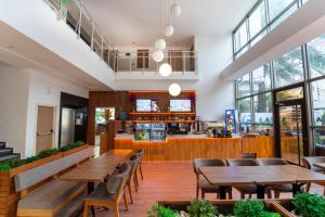 a restaurant with wooden tables and chairs and a counter at La Brisa Hotel in Antalya
