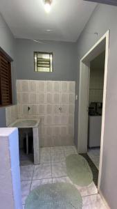 a bathroom with a shower and a sink in a room at Central APE Diamantina in Diamantina